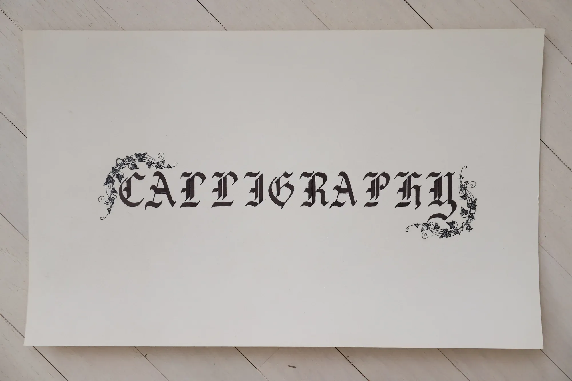 Ornate hand-lettered calligraphy piece reading “Calligraphy”
