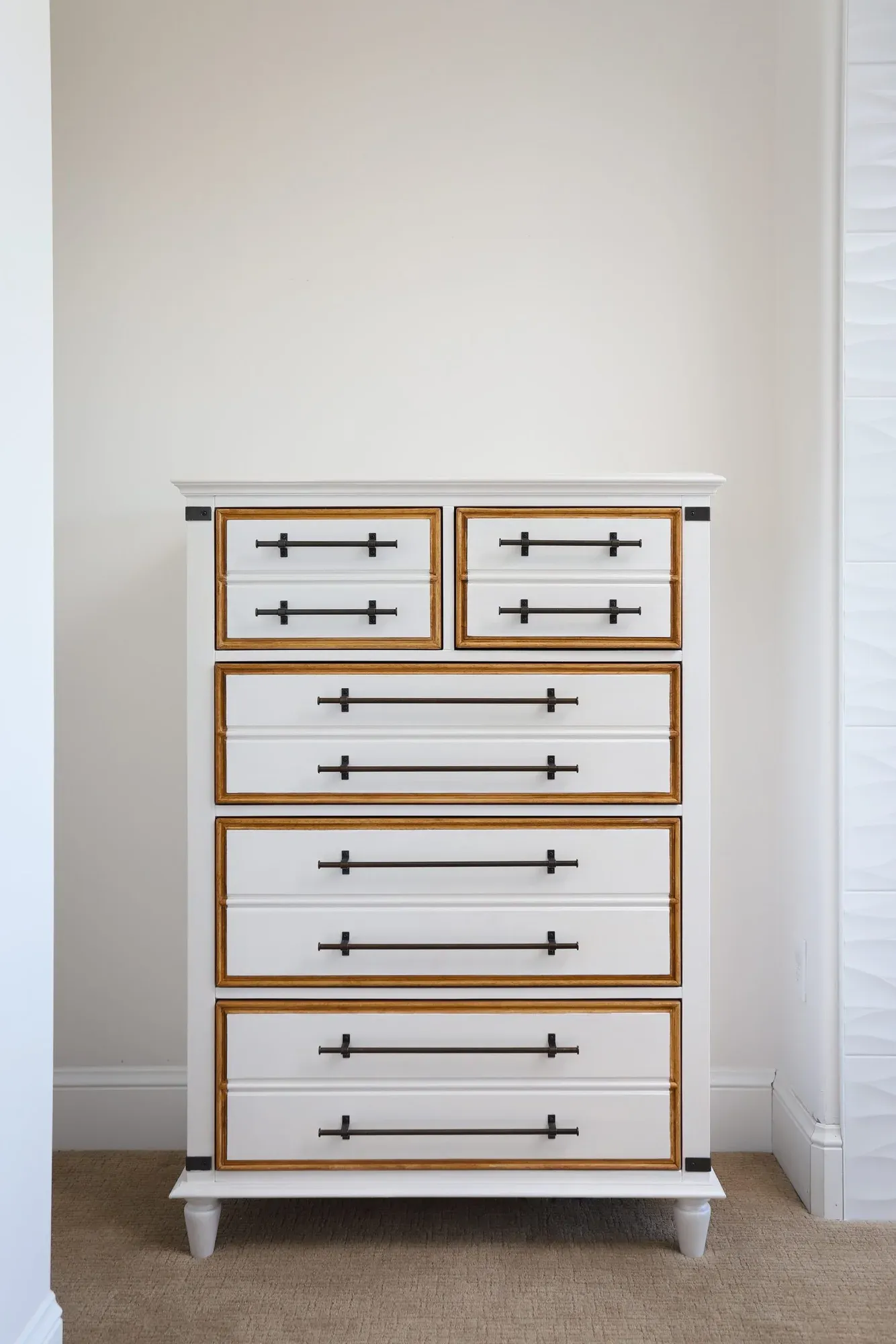 White and gold hand-painted dresser with dark hardware