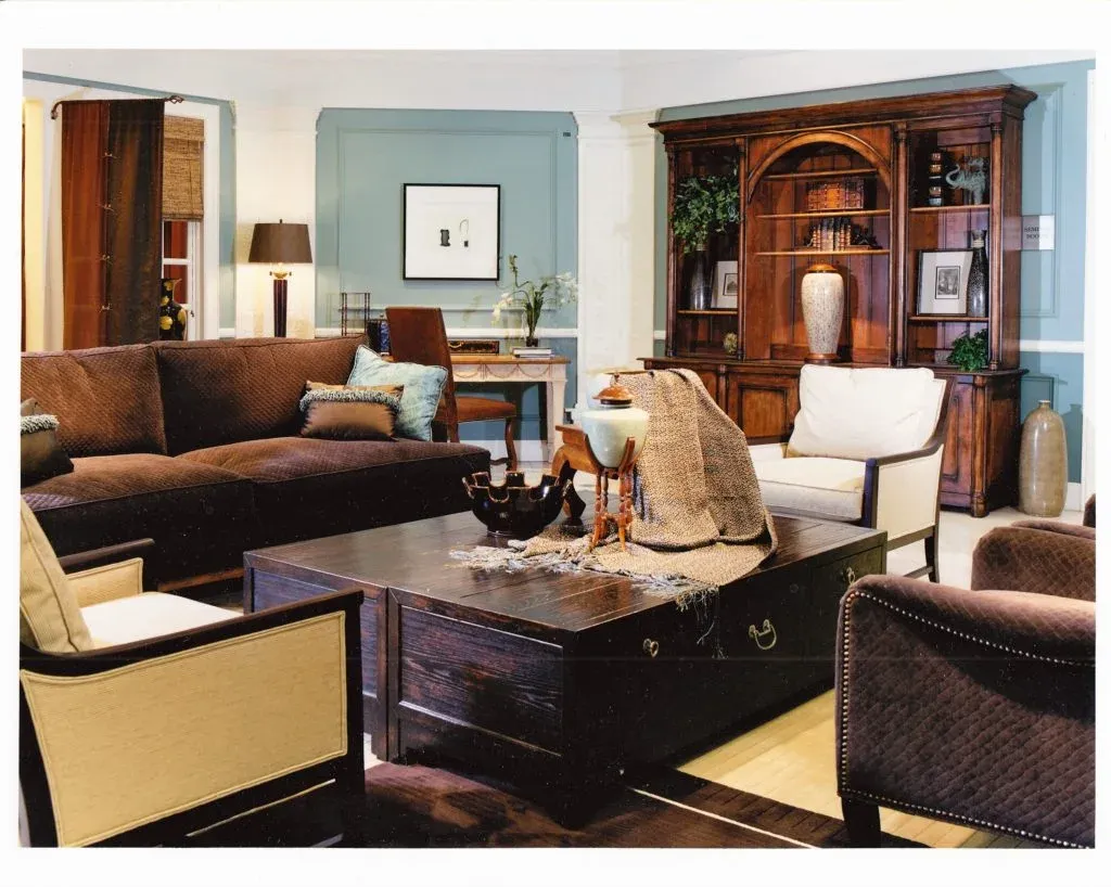 Living room with a brown sectional, wood bar cart, and a patterned rug